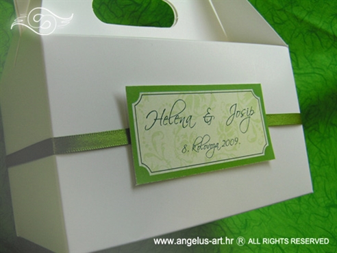bijela kutija za kolače sa zelenom trakom i imenima mladenaca