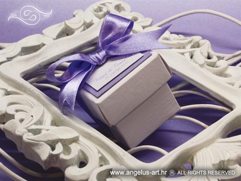 konfetna kutijica za vjenčanje s konfetnim bombonima ukrašena ljubičastom mašnom